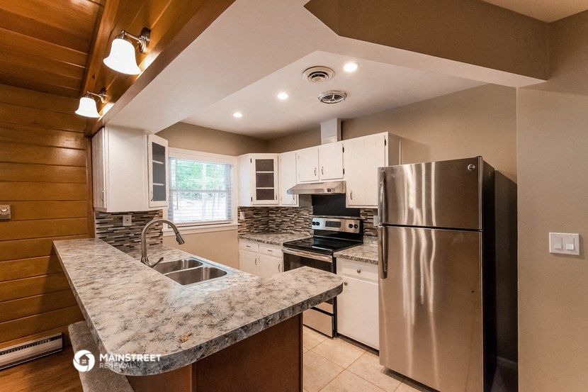 a kitchen with stainless steel appliances and granite counter tops
