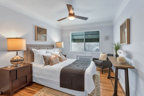 a bedroom with a bed and a ceiling fan