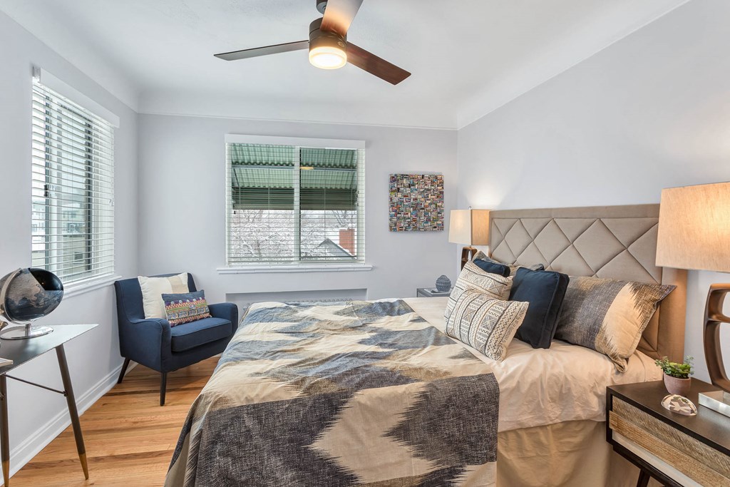 a bedroom with a bed and a ceiling fan