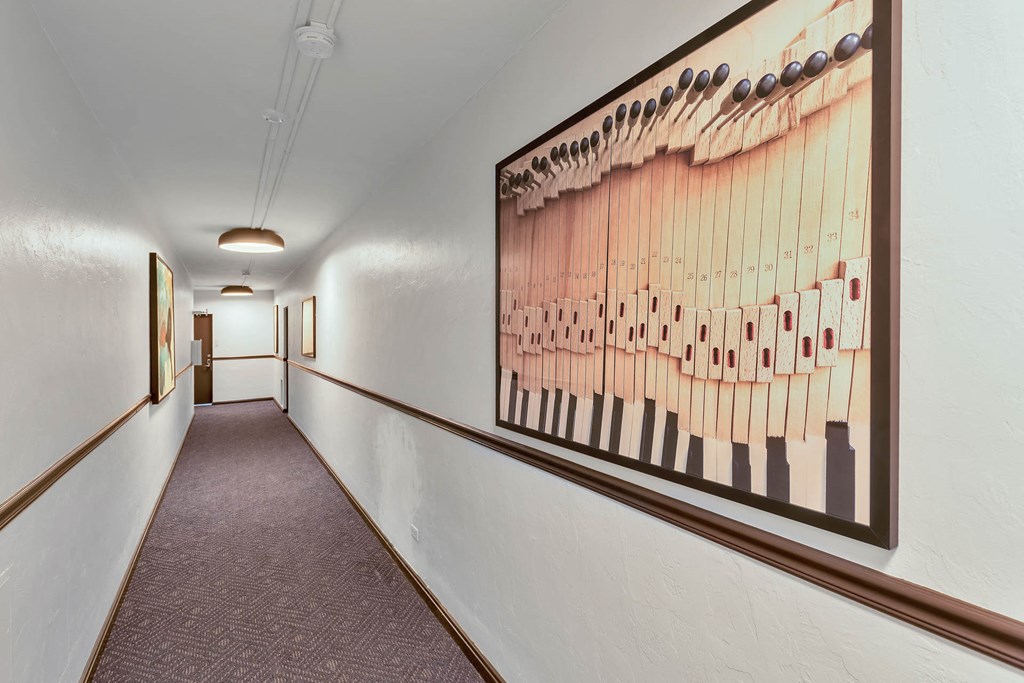 a hallway with a picture of a piano on the wall