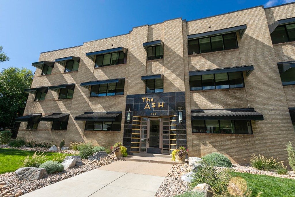 a brick building with a sidewalk in front of it