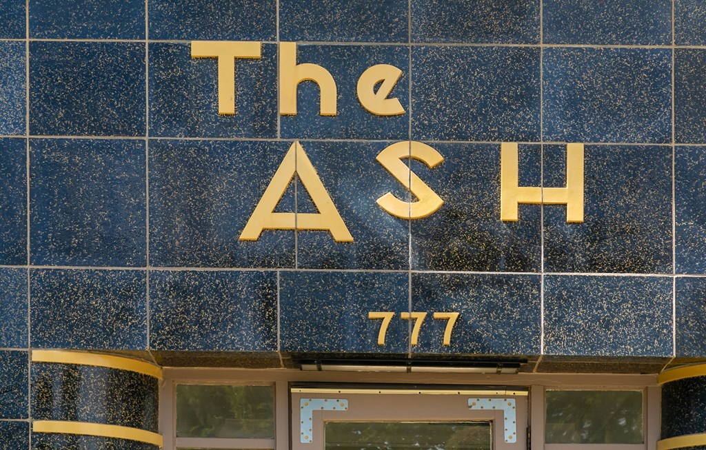 the facade of a building with a sign that reads the ash on it