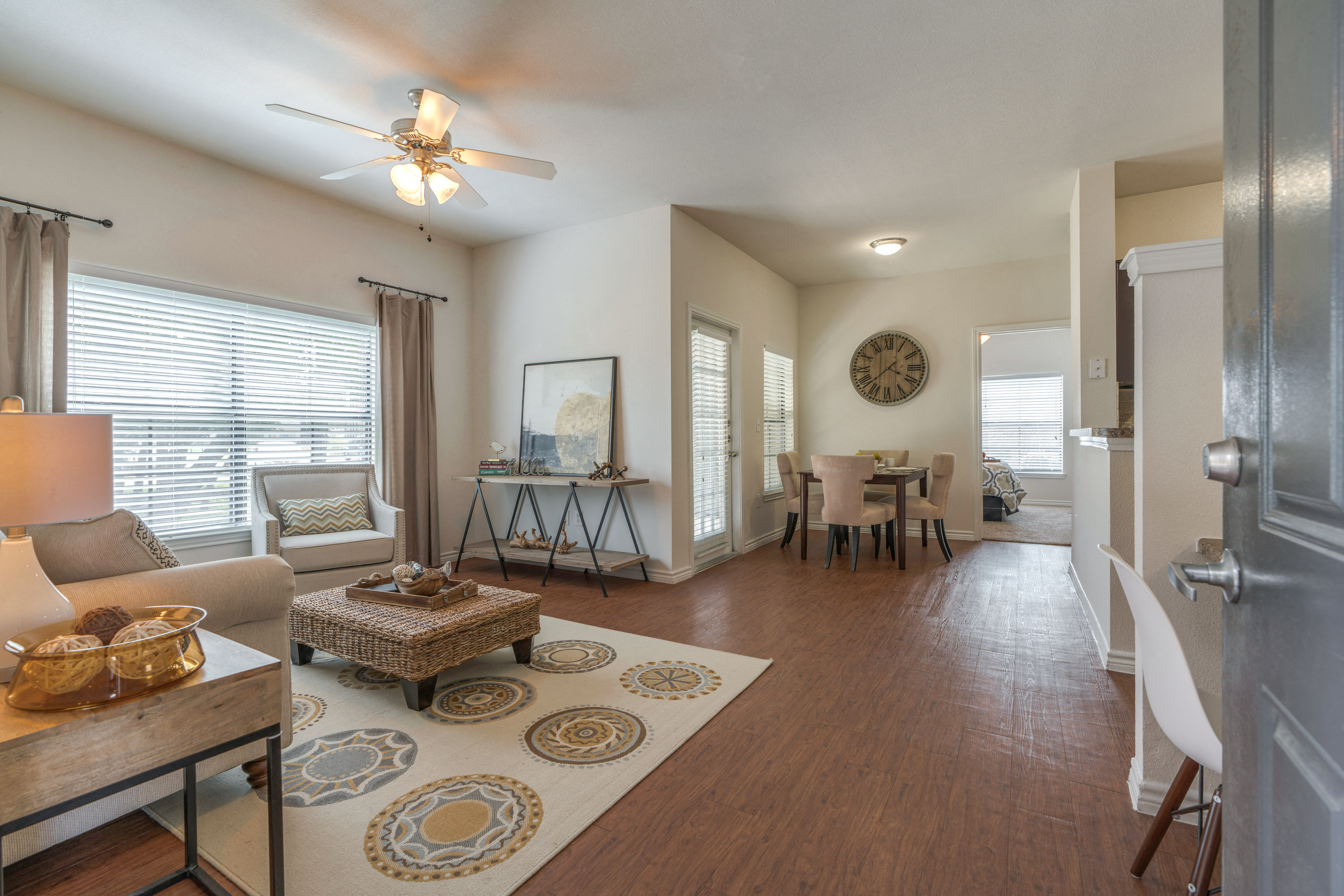 Spring TX Apartments - Edgewater at Klein - Spacious Living Room with Wood-Style Flooring and a Dining Nook