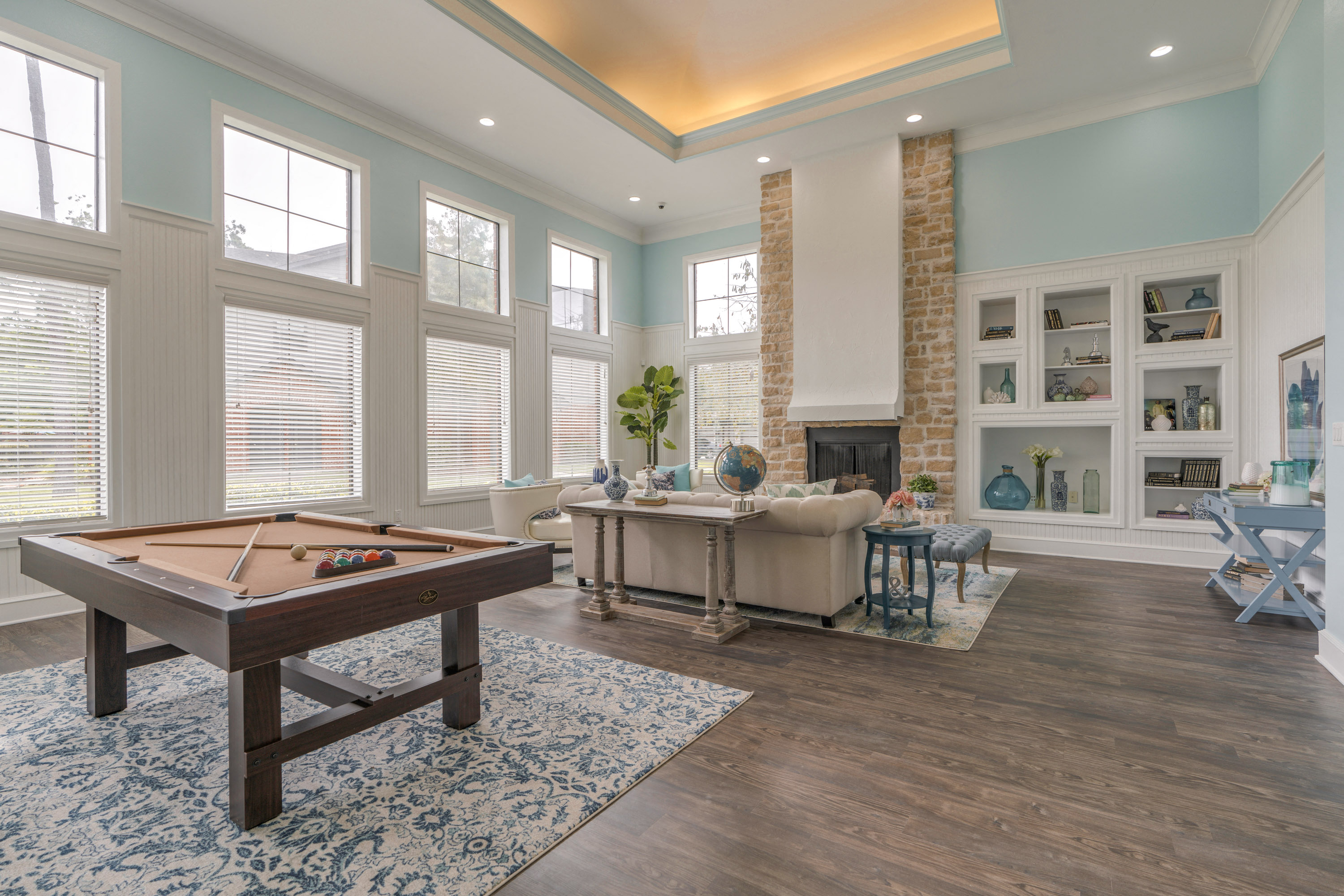 a living room with a pool table and a fireplace