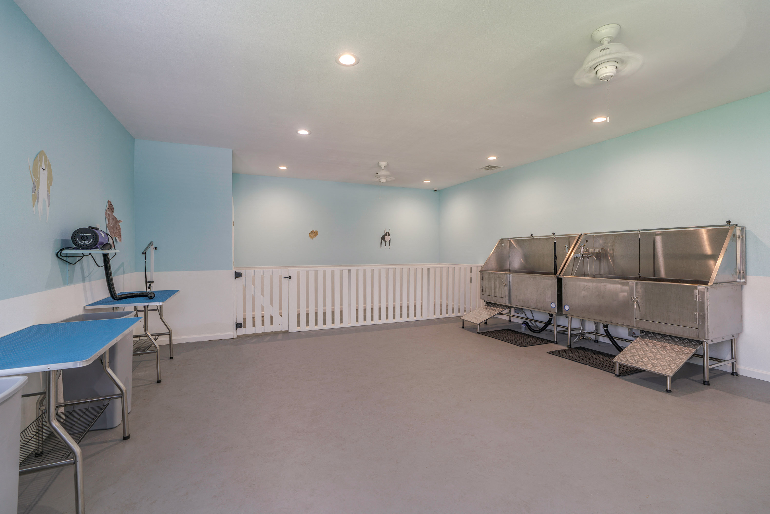 a room with two stainless steel hot dogs and a table