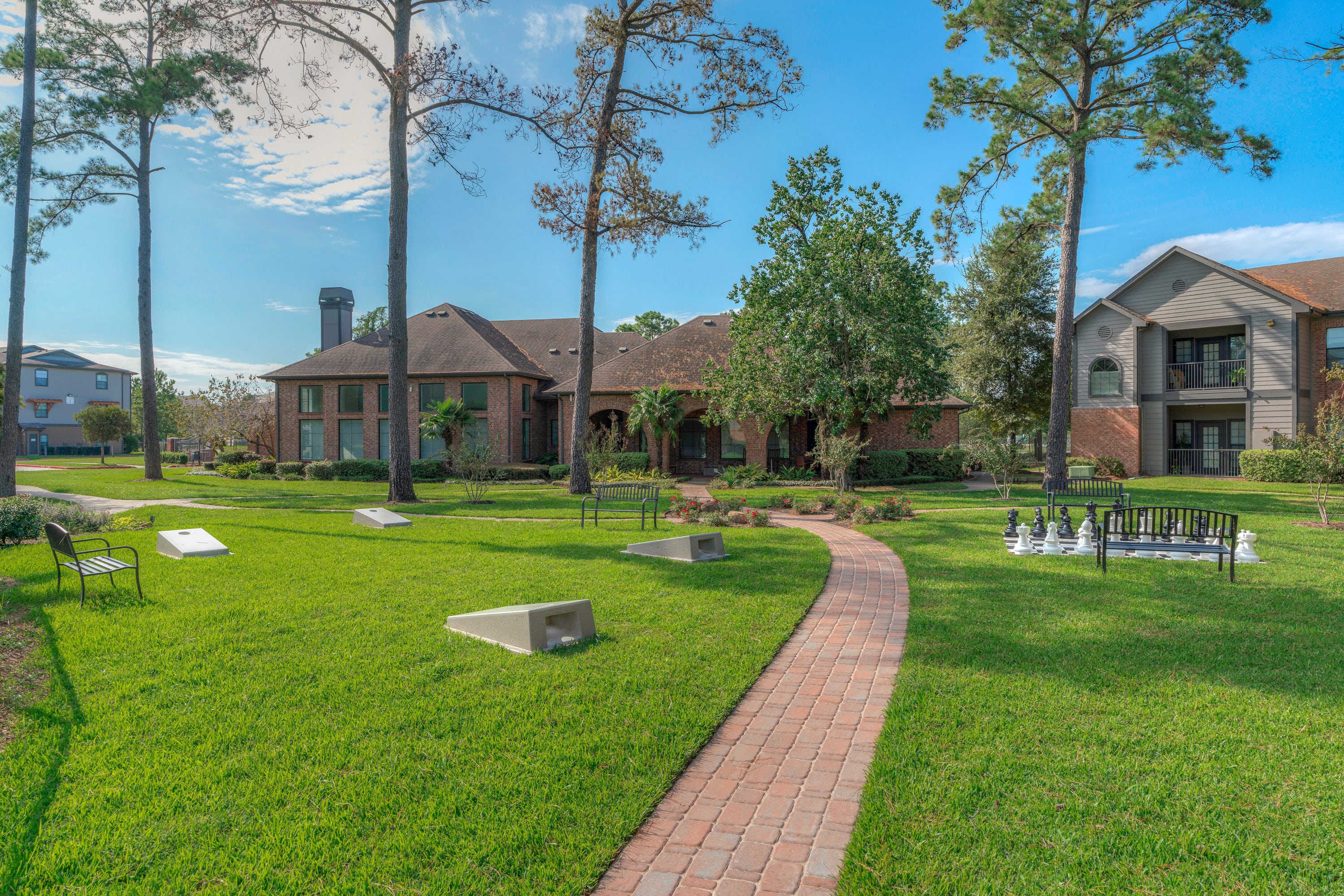a yard with benches and a house in the background