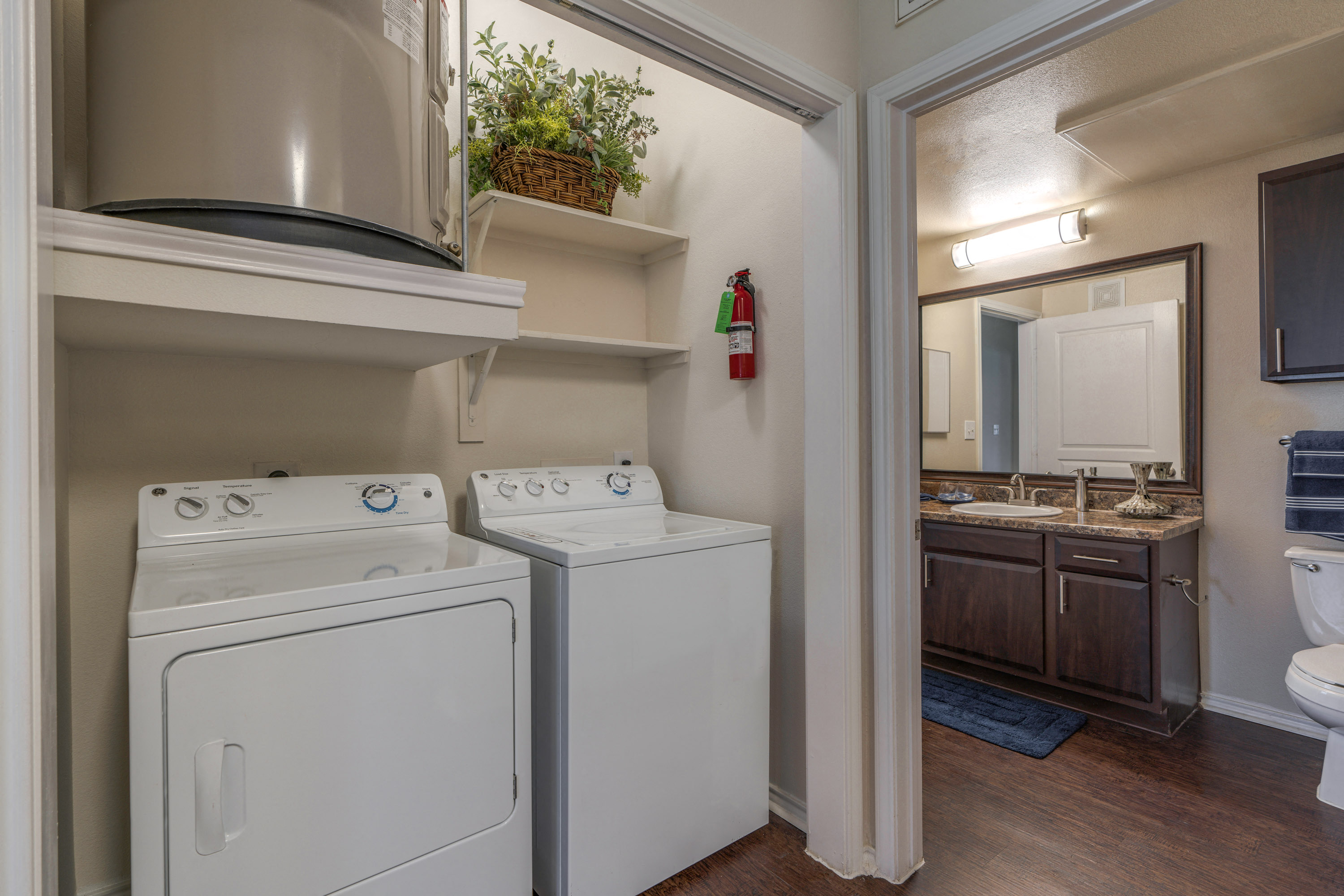 a laundry room with a washer and dryer and a bathroom with a sink