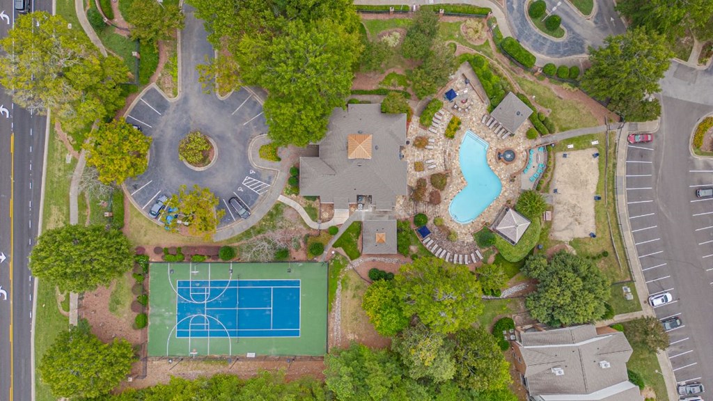 a birds eye view of a park with a tennis court and a pool