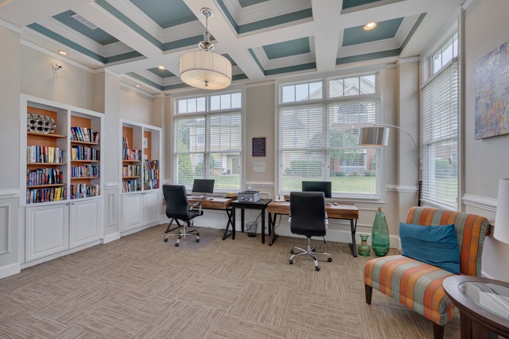 a conference room with a table and chairs and windows
