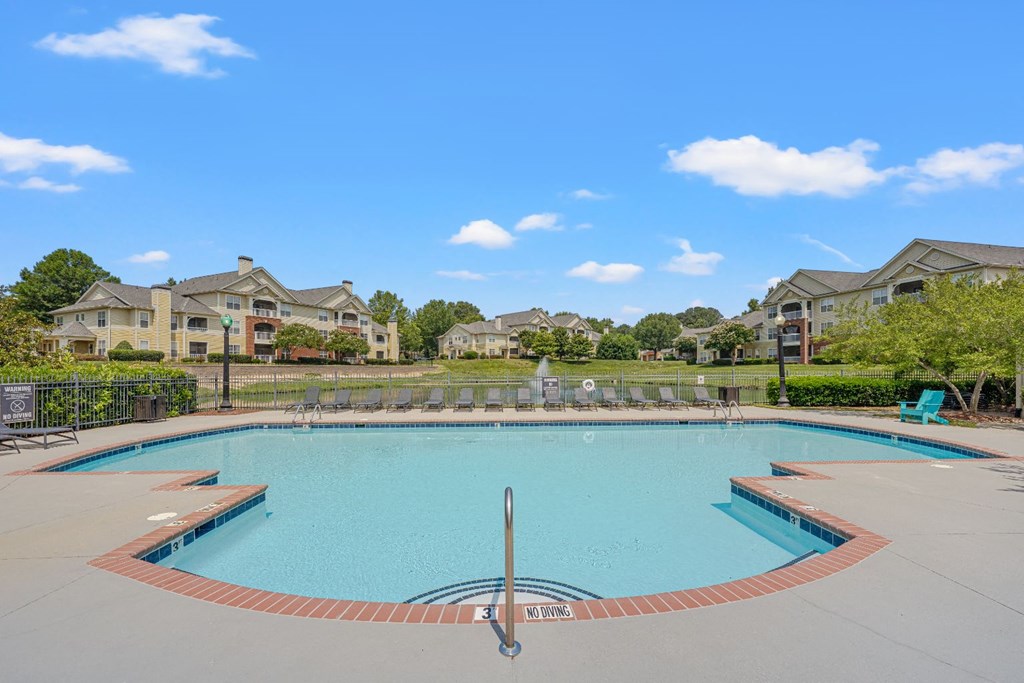 a swimming pool with apartments in the background
