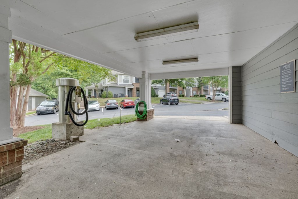 the driveway of a parking garage with a gas pump
