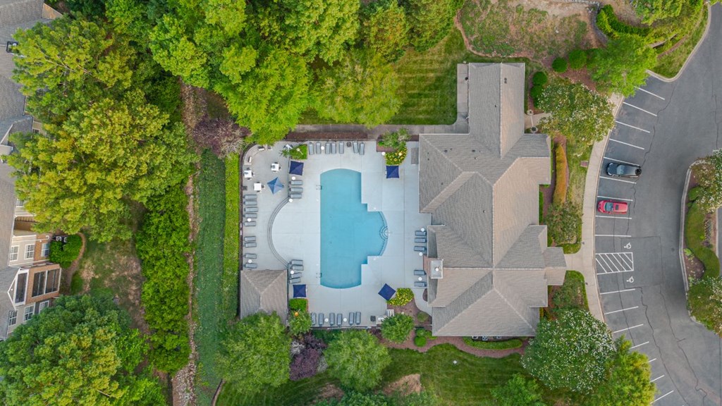 a house with a pool in the middle of a yard