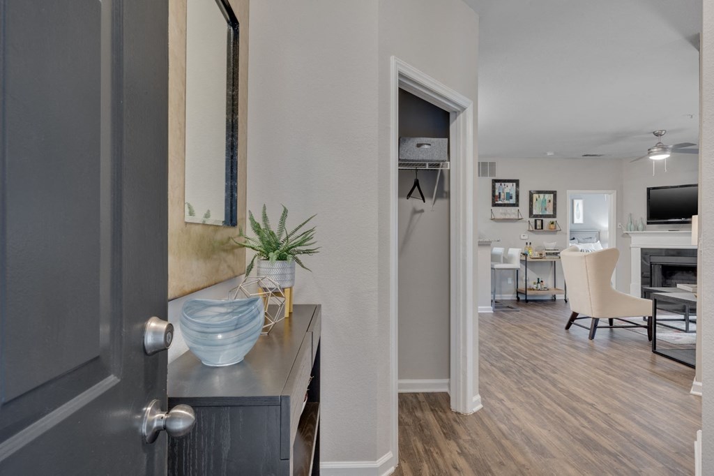 an open door leading into a kitchen and living room with a view of a kitchen