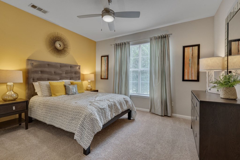 a bedroom with a bed and a ceiling fan