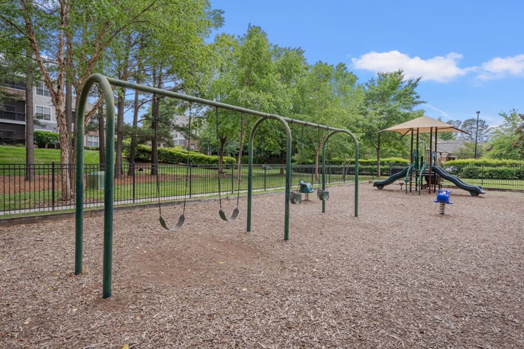 our playground is equipped with swings and a picnic table