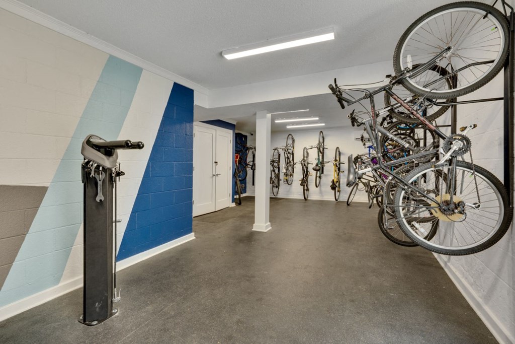 the interior of a building with bikes hanging on the wall