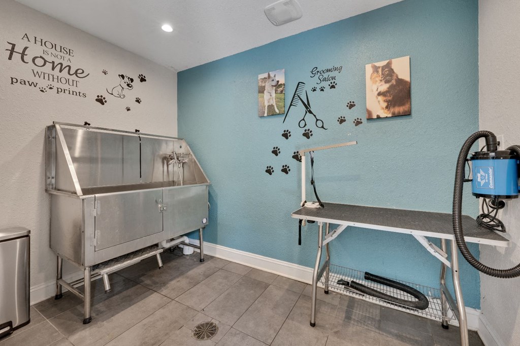 a room with a sink and a table in front of a blue wall