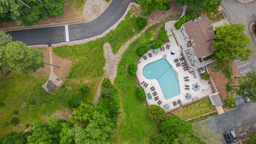 a birds eye view of a pool in a backyard with a house