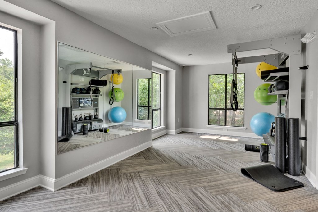 a home gym with a mirror and a weights rack