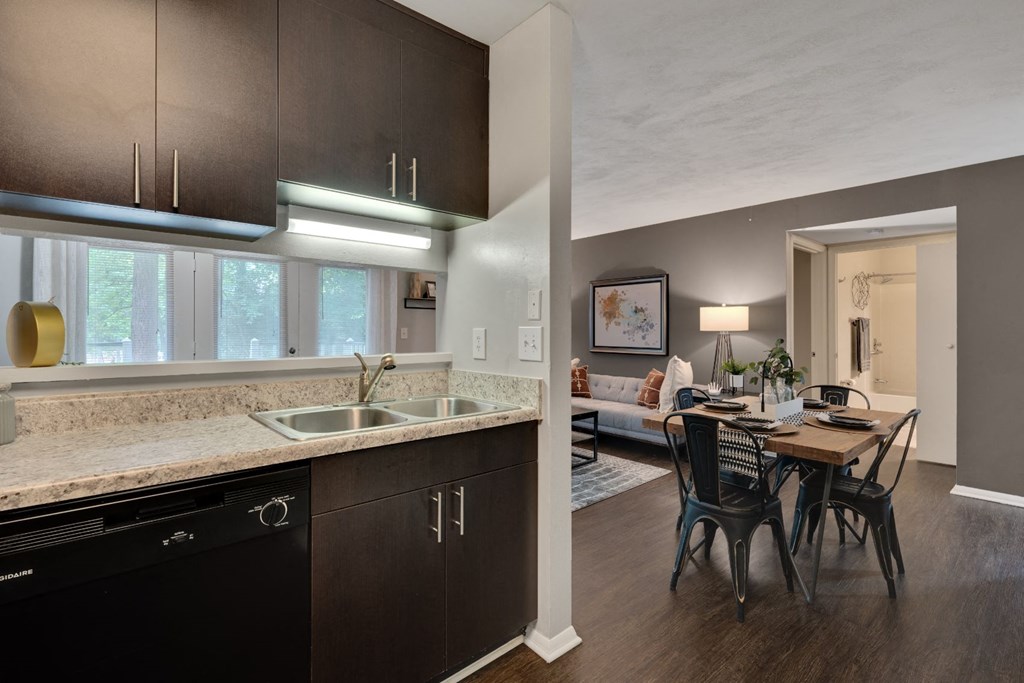 a kitchen and dining room with a table and chairs