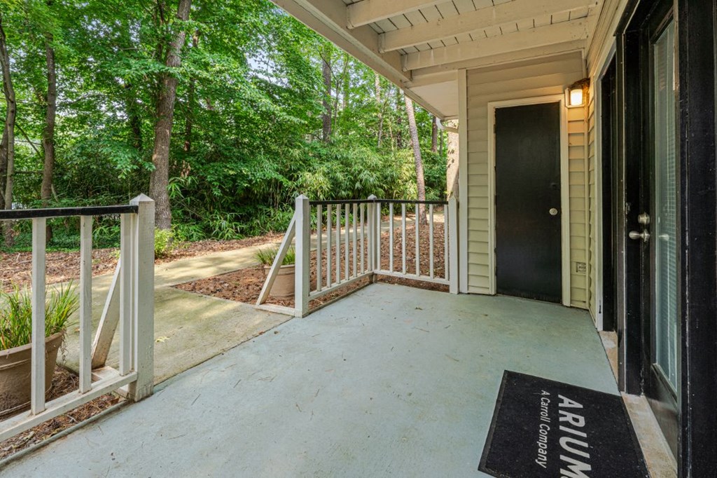 the front porch of a house with a porch swing