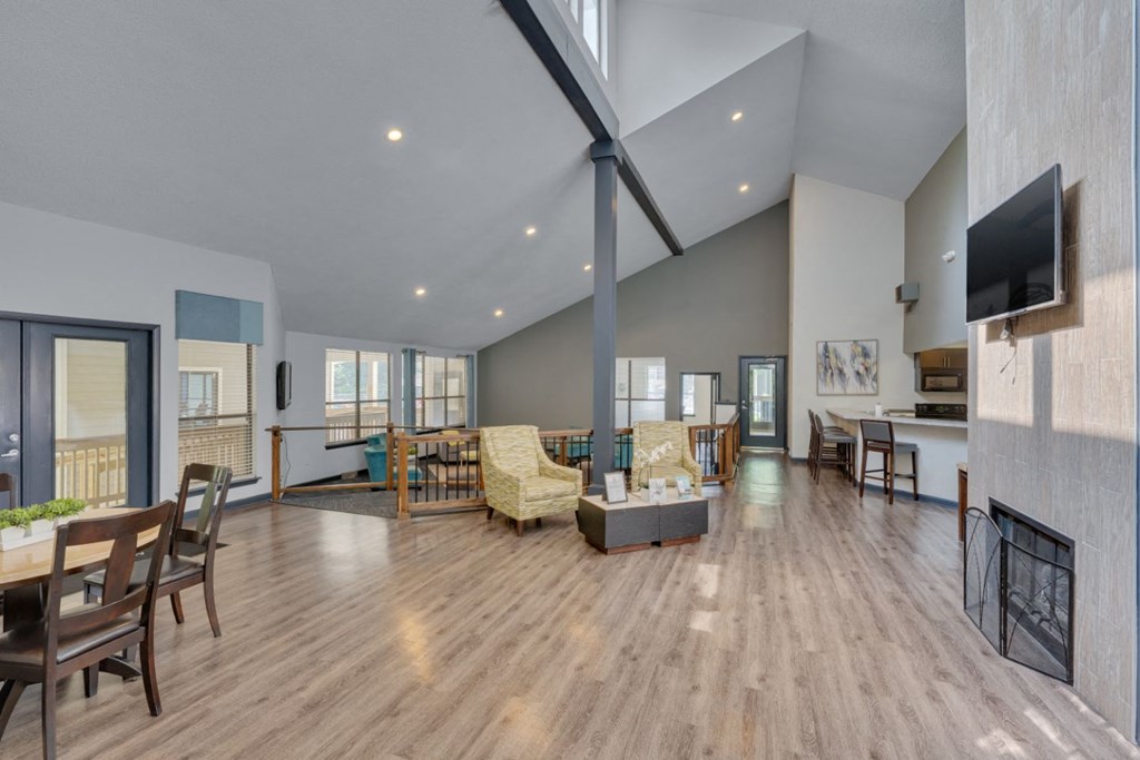 a spacious living room with a fireplace and a tv