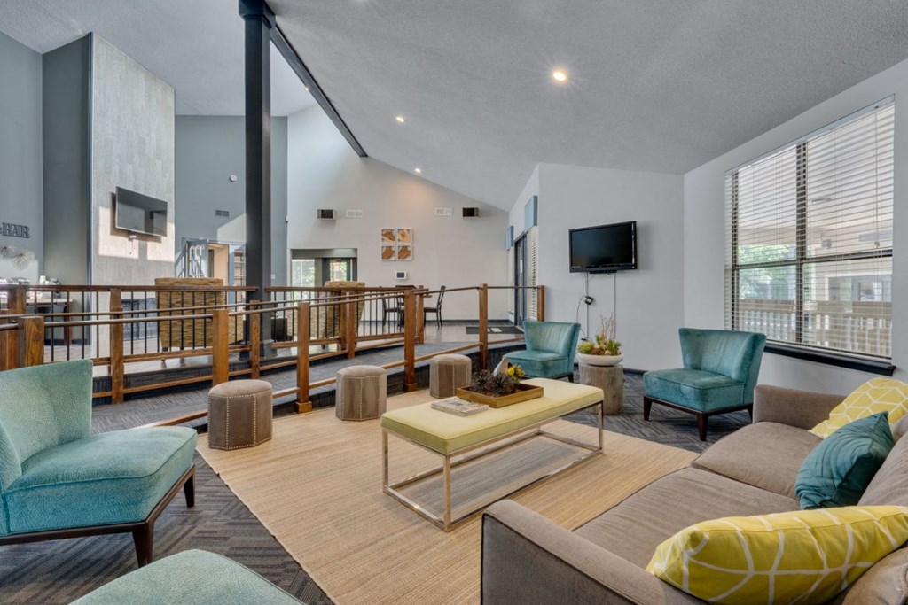 a living room with couches and chairs and a television