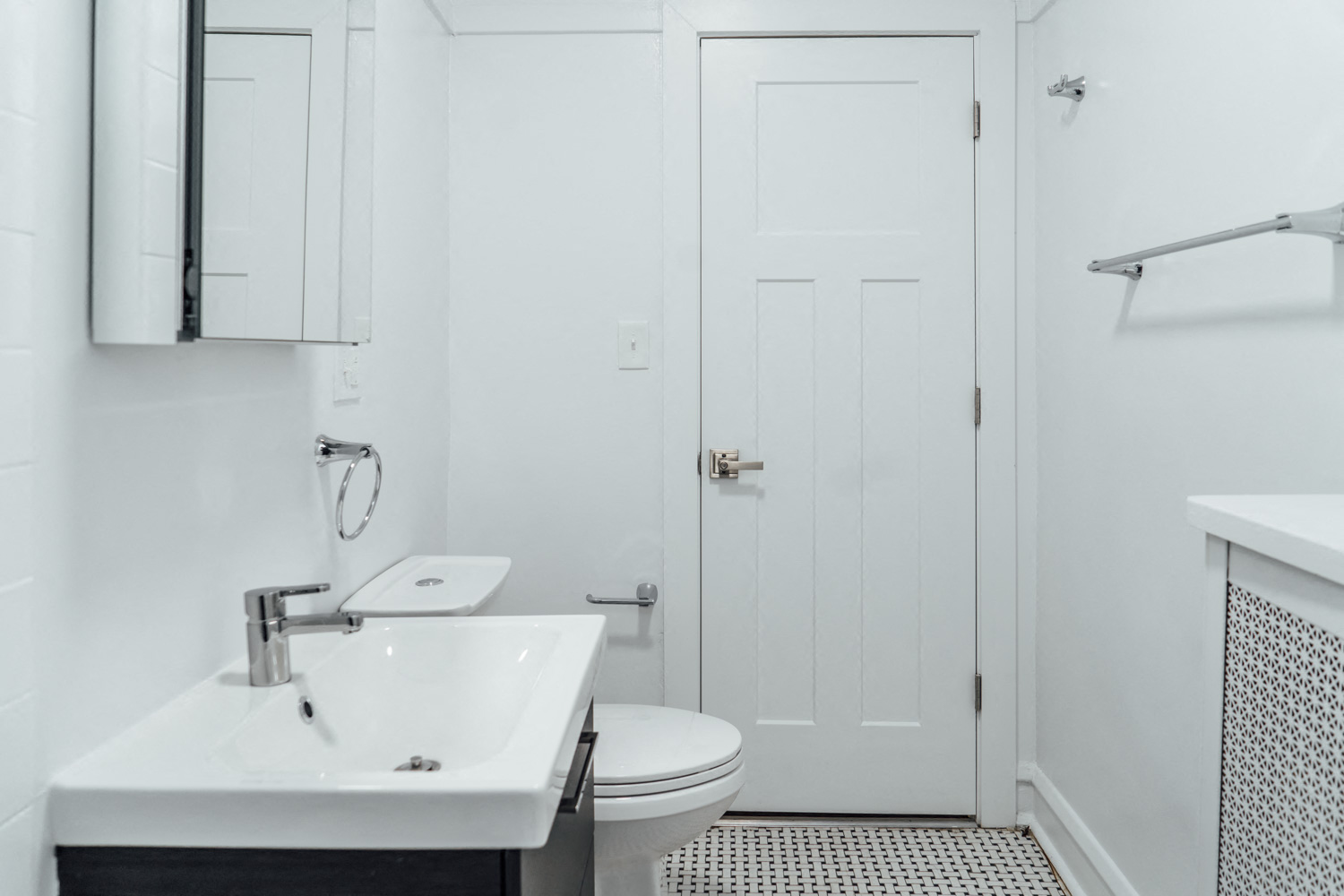 a white bathroom with a sink and a toilet