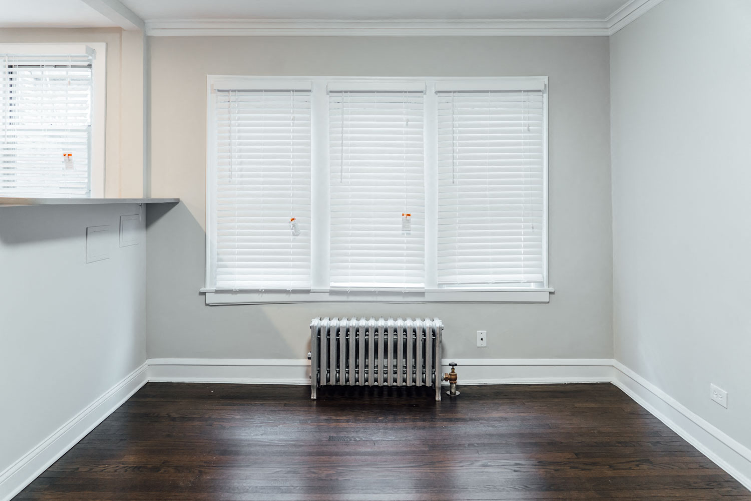 a living room with wood floors and a radiator