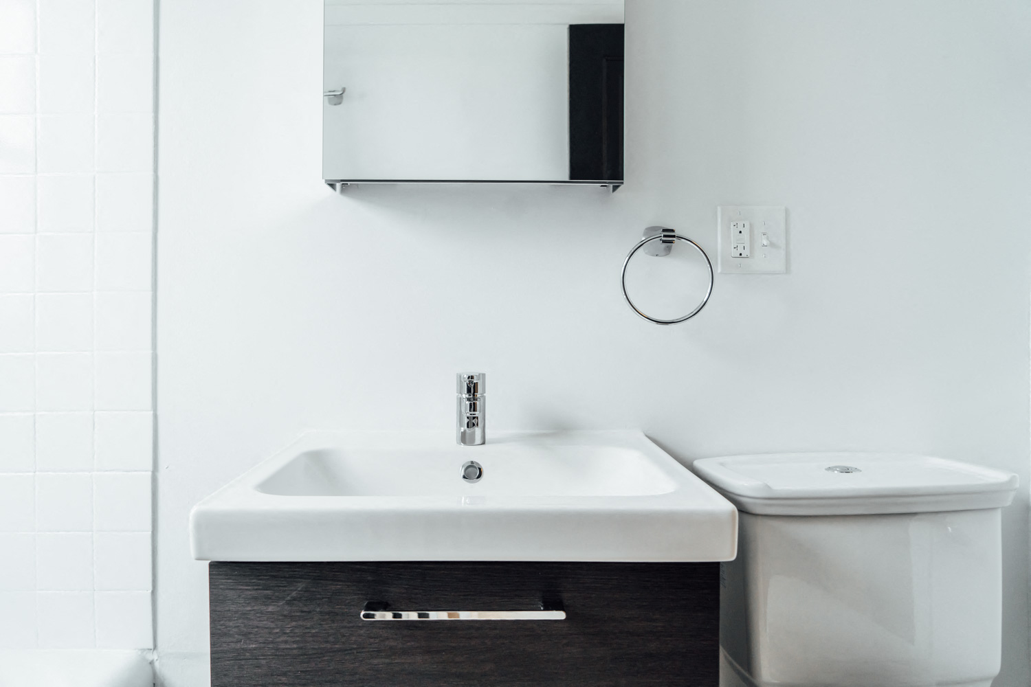 a bathroom with a sink and a mirror and a toilet