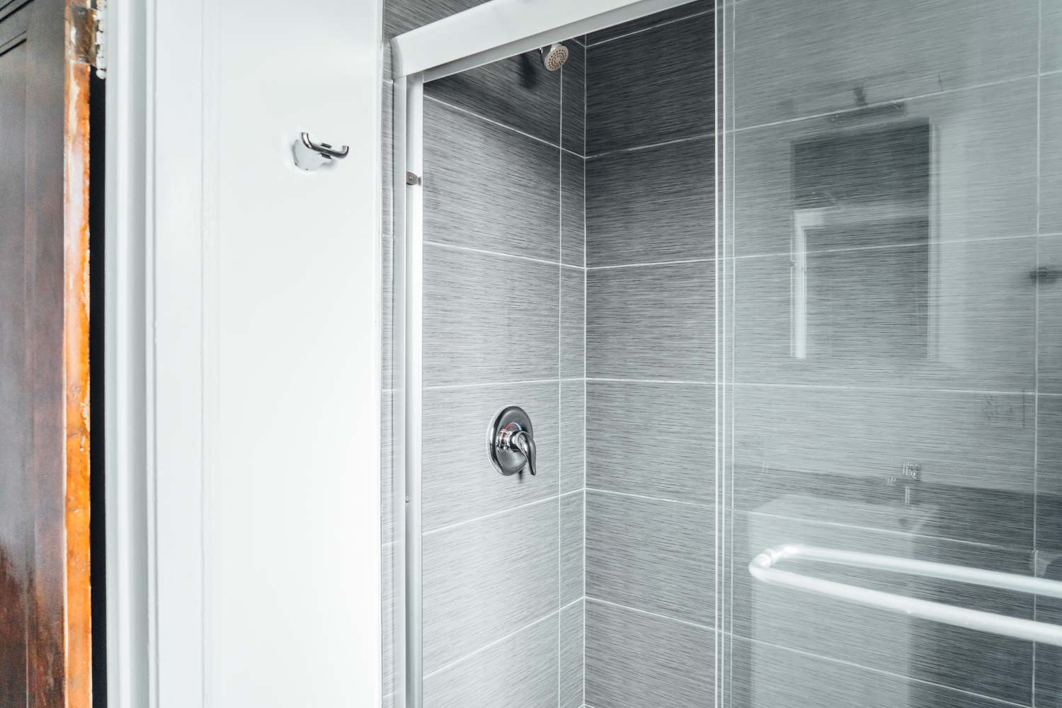 a bathroom with a shower and a glass door