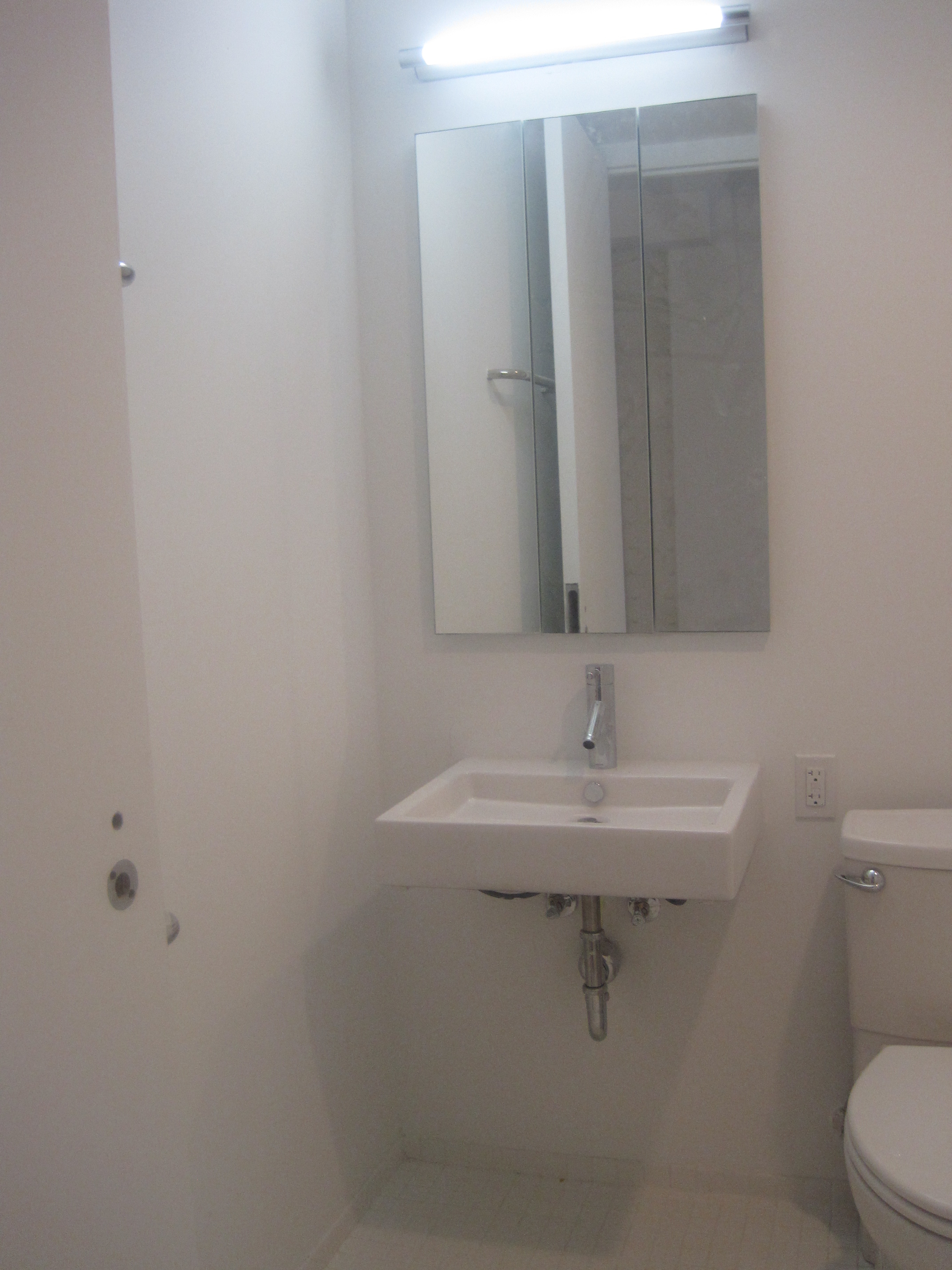 a small bathroom with a sink and a mirror