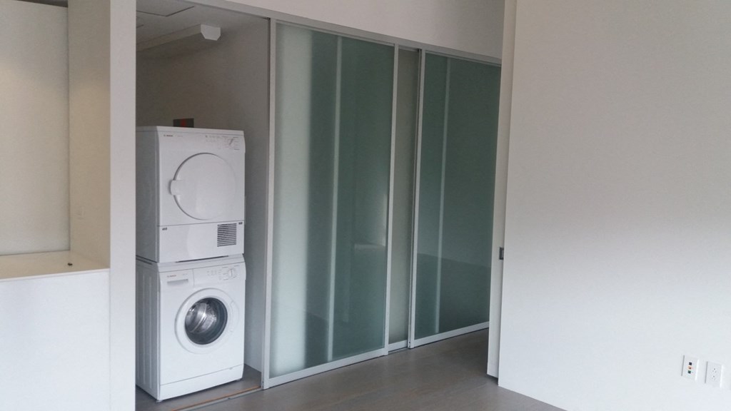 a washing machine and a dryer in a room
