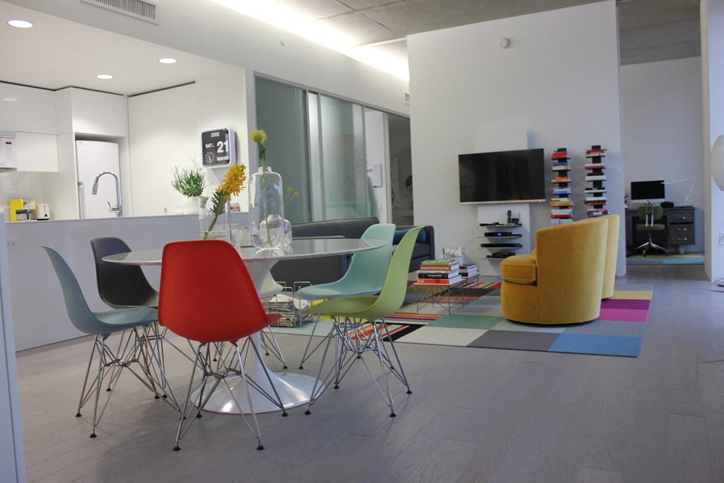 a dining room with a table and chairs and a tv