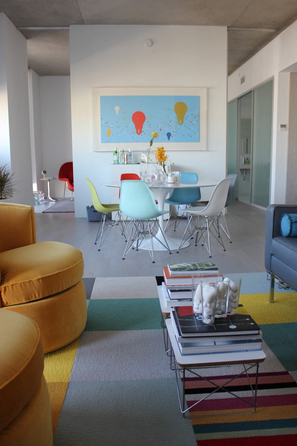 a living room with a table and chairs and a rug