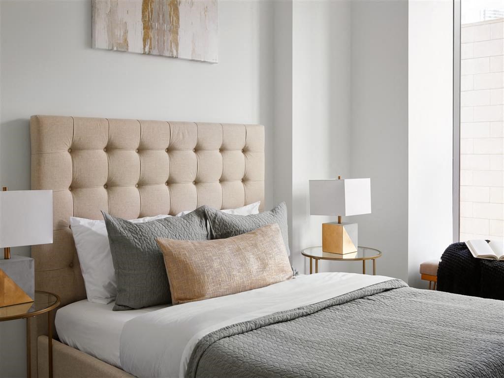 a bedroom with a bed and pillows