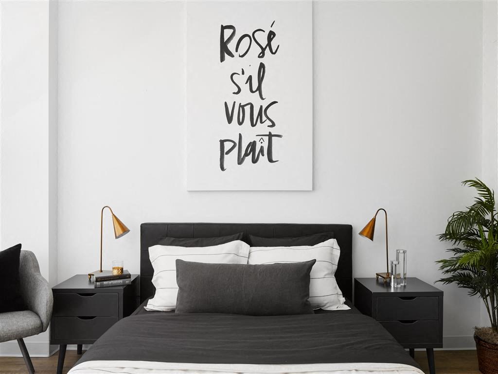 a bedroom with a bed and a quote on the wall