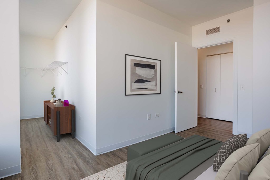A living room with a couch, a table, and a painting on the wall.