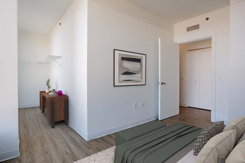 A living room with a couch, a table, and a painting on the wall.