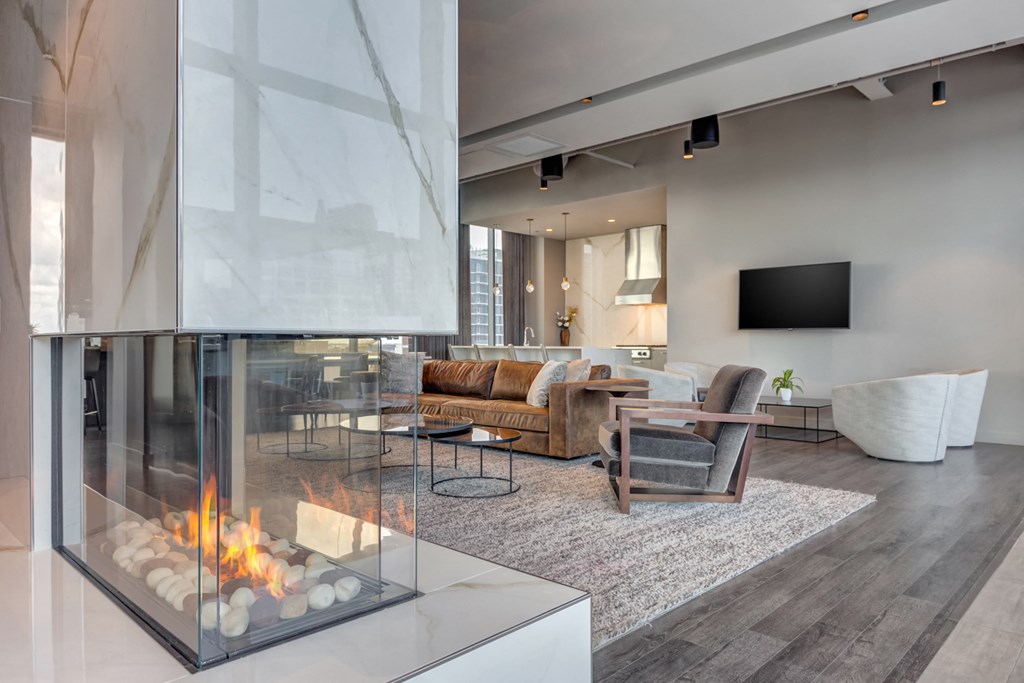 a living room with a fireplace and a large window