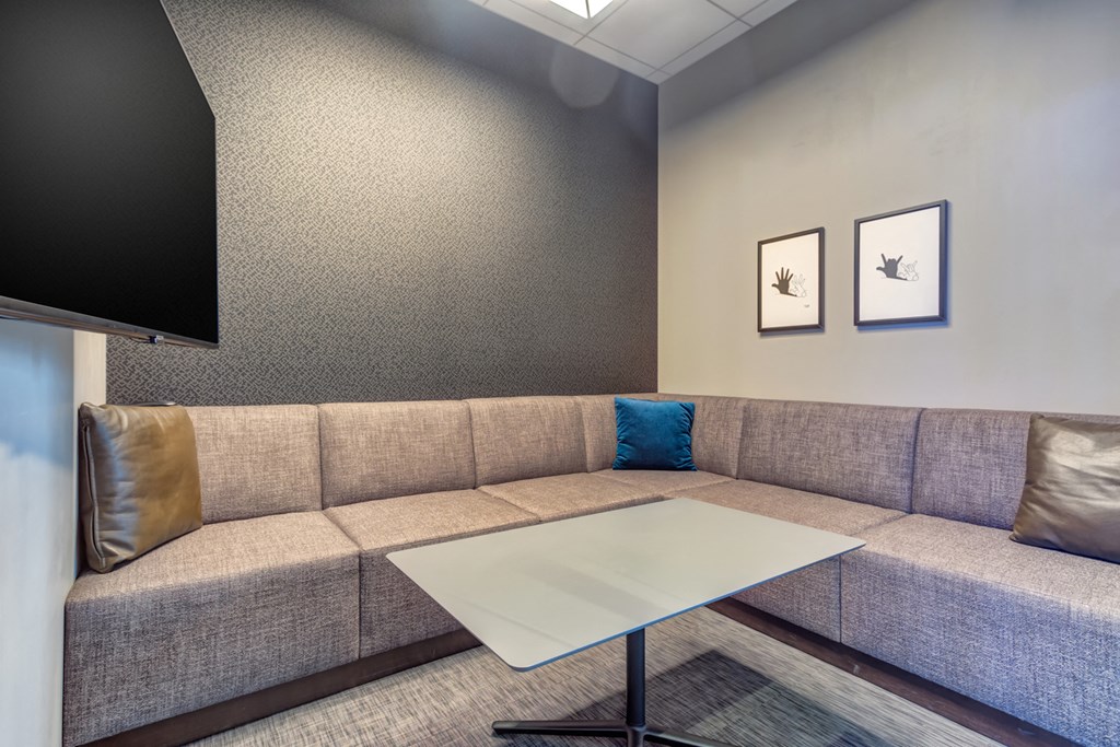 a living room with a couch and a table and a television