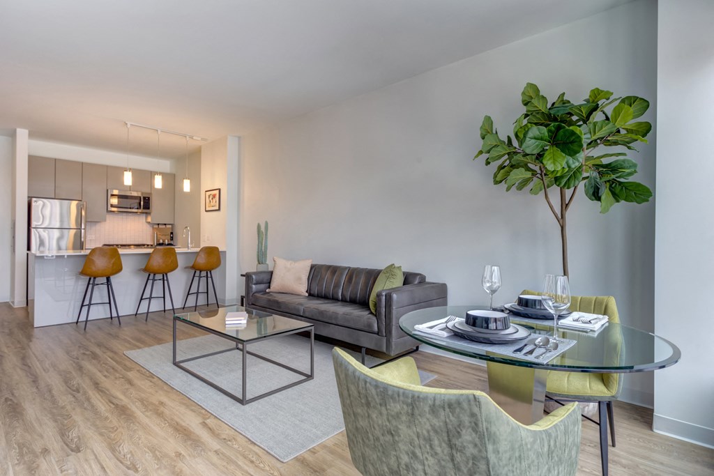 a living room with a glass table and a couch