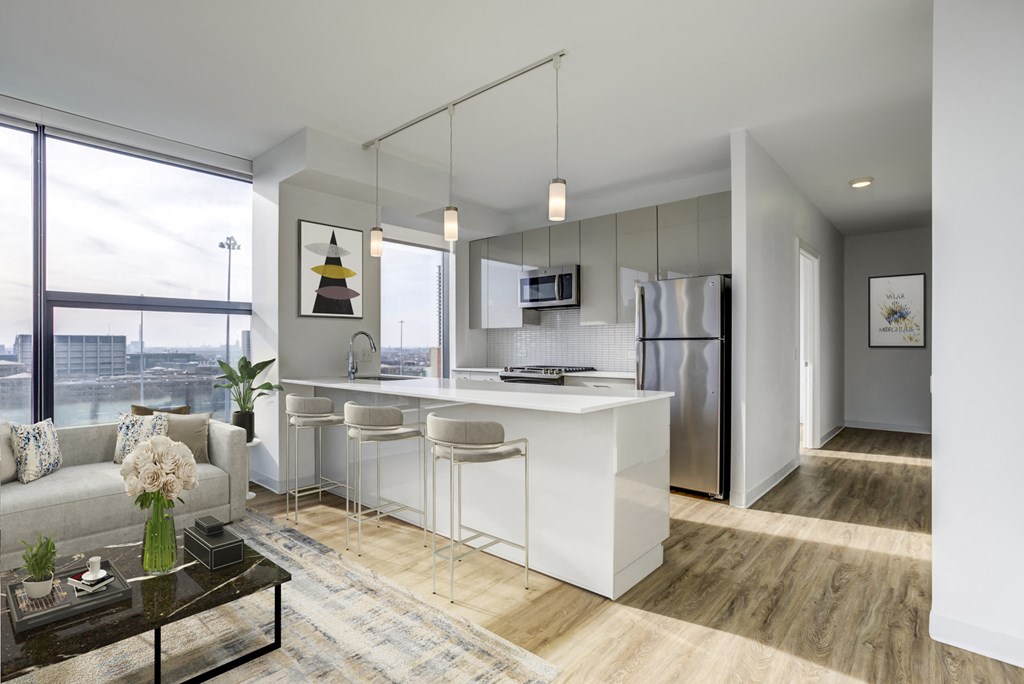 an open kitchen and living room with a white