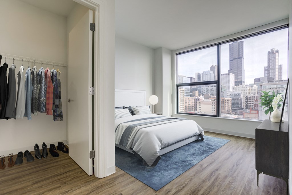 a bedroom with a bed and a large window