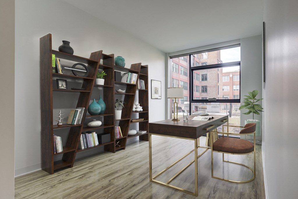 a home office with a desk and a large window
