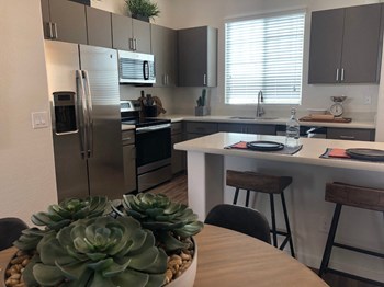 Kitchen with Breakfast Bar at Avilla Camelback Apartments in Phoenix Arizona - Photo Gallery 5