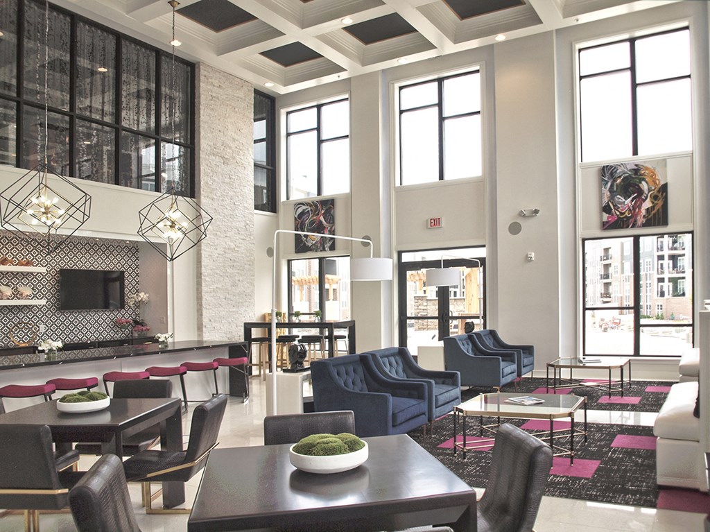 a rendering of a lobby with tables and chairs and a fireplace