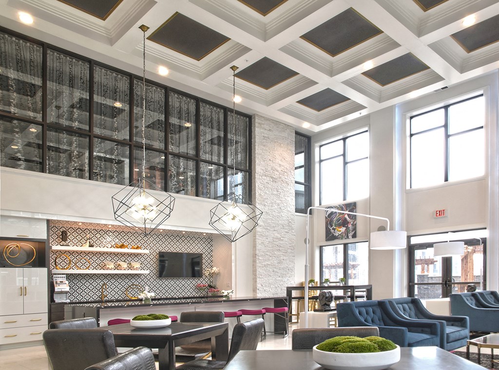 a living room with tables and chairs and a fireplace