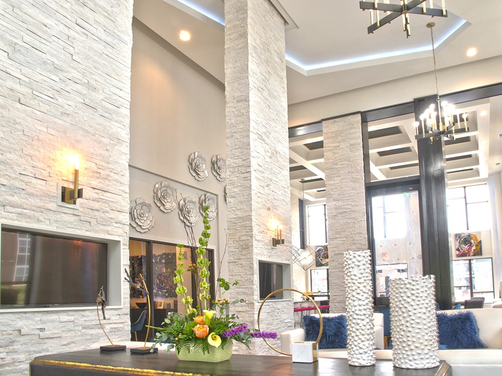 a living room with a fireplace and a table with flowers