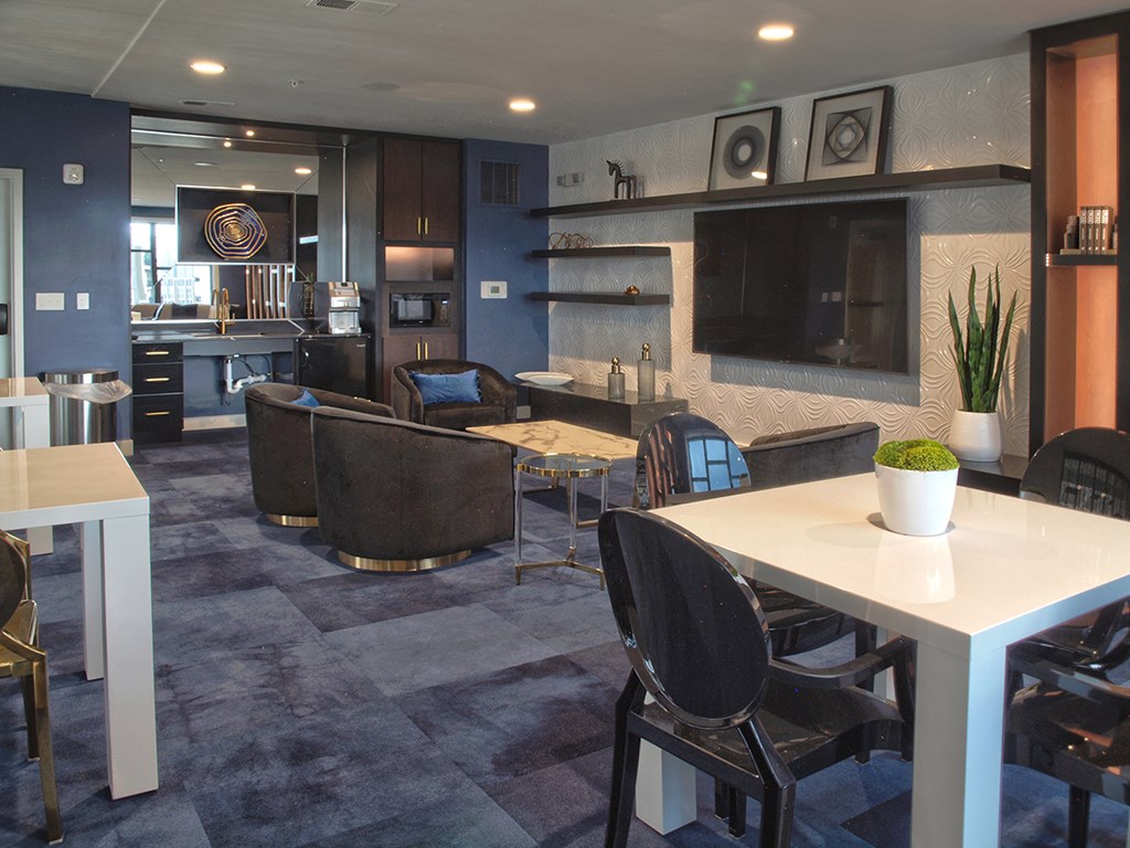 a conference room with tables and chairs and a tv